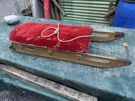 Antiker Schlitten Holz Metall rot Stoffbezug