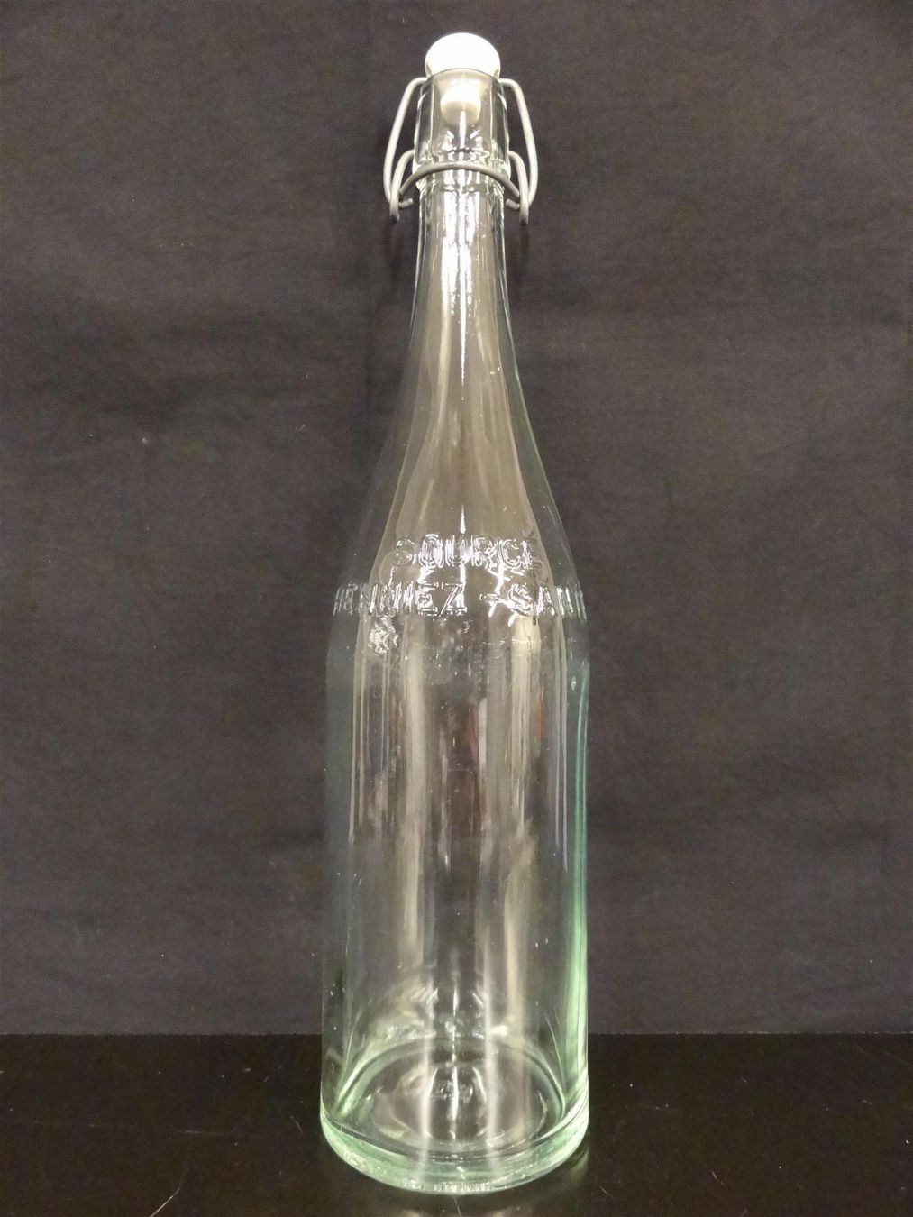 Bicchieri, Caraffe & Bottiglie: alte Flasche HENNIEZ SANTÉ 1964 – Usato da Kerzers venduto da Flaschenposten