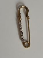 Gold safety pin brooch with rhinestones 