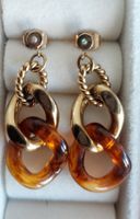 Paire de boucles d'oreilles pendantes chaîne Lotus dorées