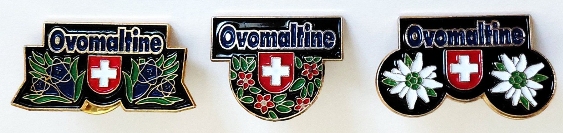 Ovomaltine Plaketten & Abzeichen: 3 Pin's Ovomaltine – Gebraucht aus Luzern von qualifair