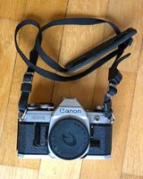 Canon AE-1 Body Analog-Kamera in silber mit Tragegurt