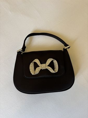 Petit sac noir avec nœud brillant 