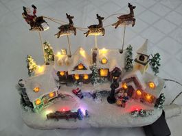 Décoration Noël LED Luminéo avec père Noël  et rennes mobile