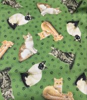 Patchworkstoff Katzen auf grünen Grund