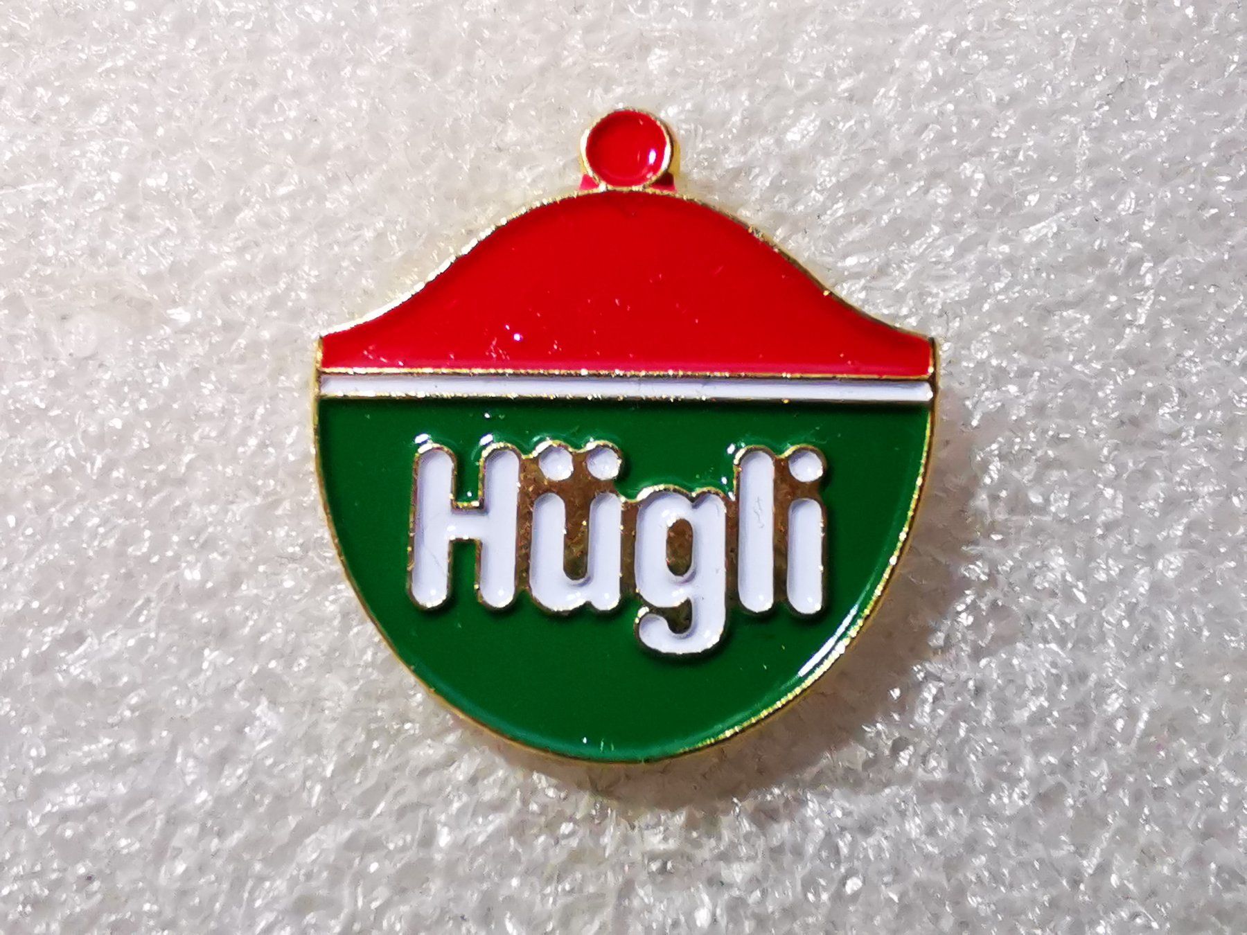 Plaketten & Abzeichen: Ansteckpin 41: Hügli – Gebraucht aus Oppligen von Pin-Fall-Shop