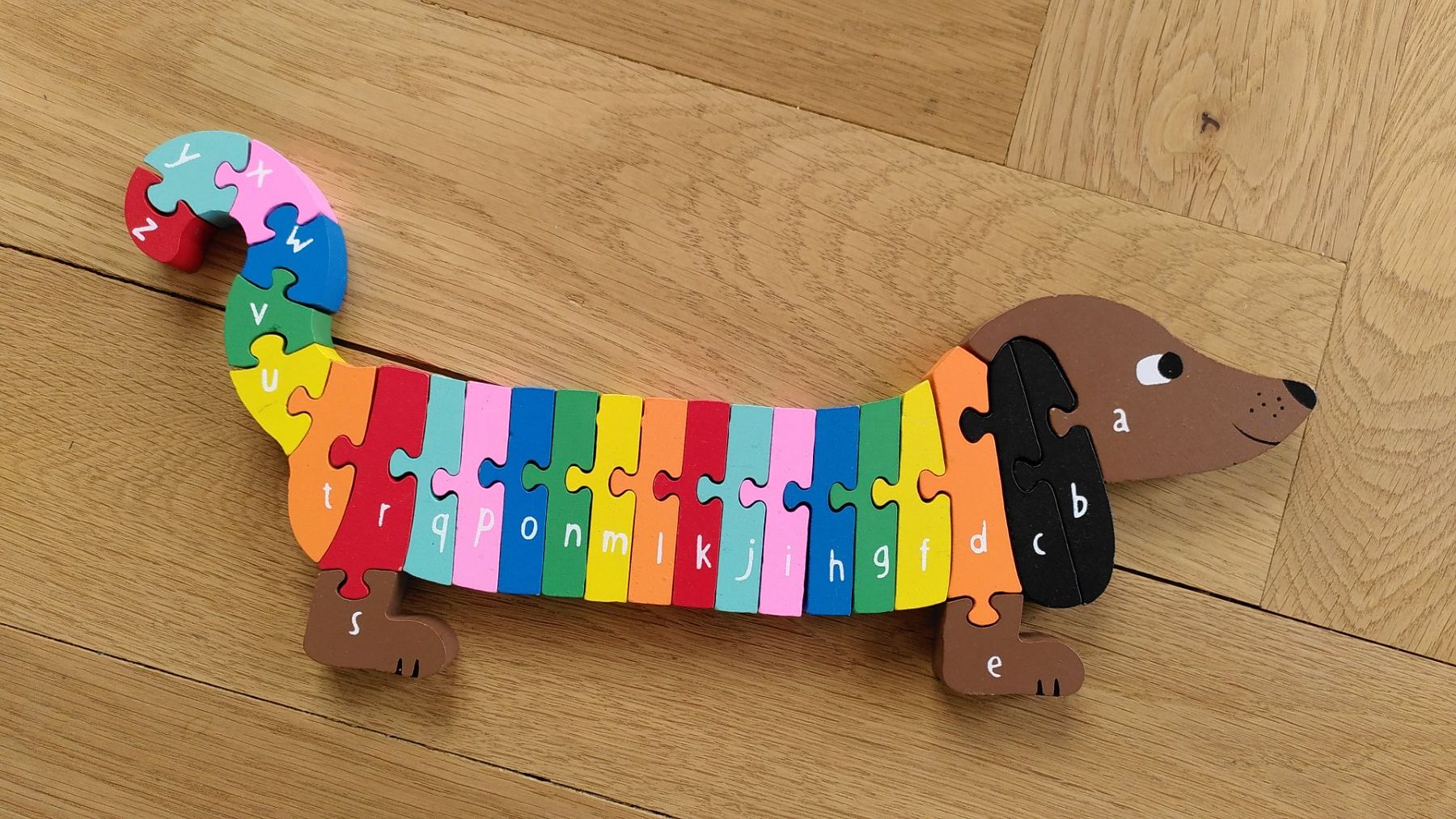 Puzzles: Holzpuzzle Dackel mit ABC – Gebraucht aus Zürich von Weluma
