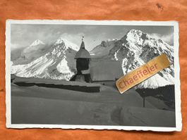 Alte Ansichtskarte Arosa ?, Kirchli am Abend, Winter 1925