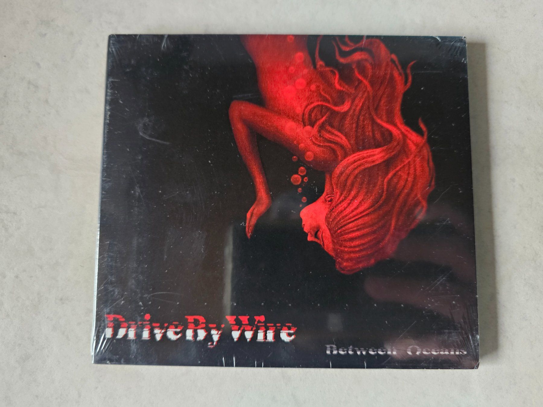 CD: Drive By Wire  -  Between Oceans  /  Fabrikneu – Nuovo e nell'imballaggio originale da Schneisingen venduto da backstore24