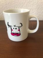 Mug en porcelaine décor vache blanc bon état.