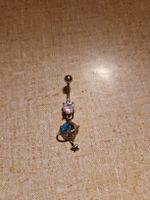 Bauchnabelpiercing mit Planet 