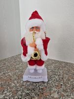 Weihnachtsmann spielt Saxofon, blinkt und wackelt