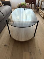 Couchtisch oval Glasplatte rauchfarben mit Holzablage