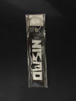 Portachiavi Nismo nero in tessuto nuovo imballato