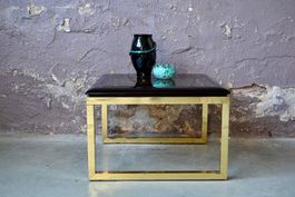 Table basse vintage noire et dorée hollywood regency design