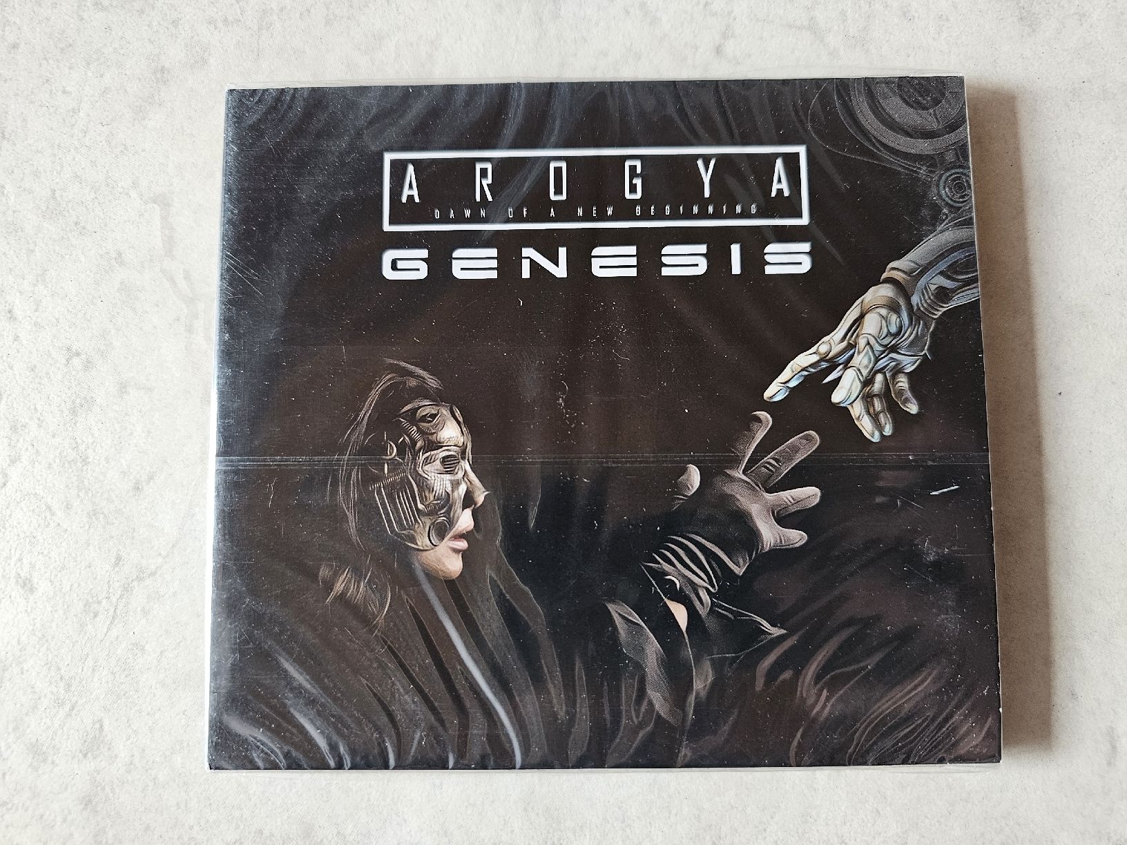 CD: Arogya  -  Genesis  /  Fabrikneu – Nuovo e nell'imballaggio originale da Schneisingen venduto da backstore24