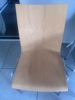 4 wooden and metal stacking chairs, in new condition.