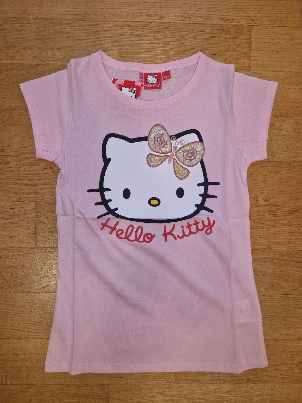 Camicette, T-shirt & Top: T-shirt Hello Kitty rose, neuf, taille 8 ans – Nuovo e nell'imballaggio originale da Penthaz venduto da Sosotroc