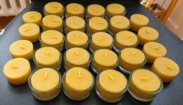 28 Beeswax tealight candles with 20 glass holders