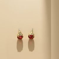 Gold Tone Stud Earrings with Ruby Red Faceted Jewel