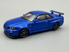 Nissan Skyline GTR R34 V-SPEC II Lim.Ed.1:64 blau neu OVP