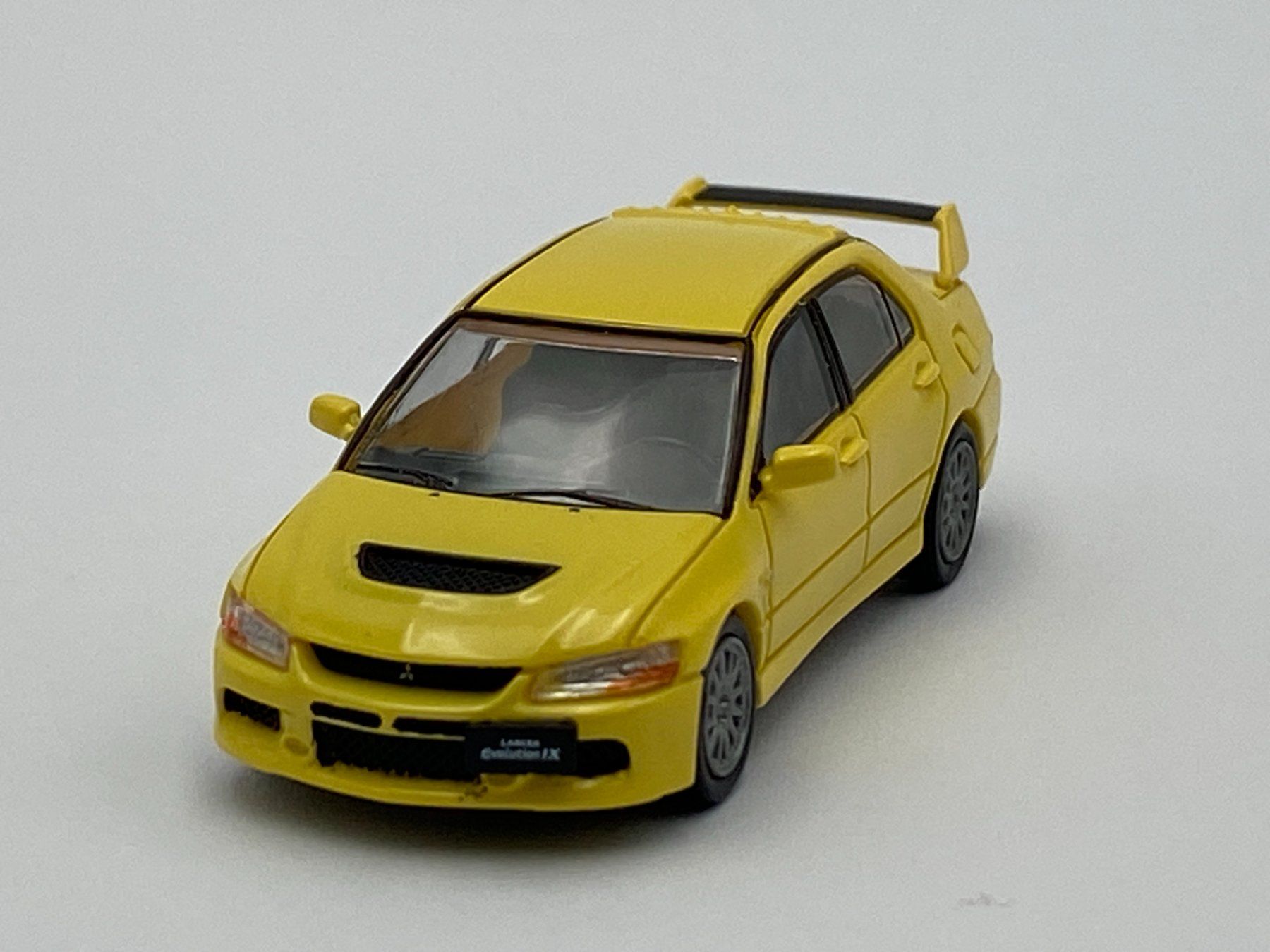 Mitsubishi Modellini d'auto: Herpa 87MC000004 1:87 Mitsubishi Lancer Evolution 9 gelb – Nuovo e nell'imballaggio originale da Neukirch a.d. Thur venduto da MoBa-Artikel.ch 1