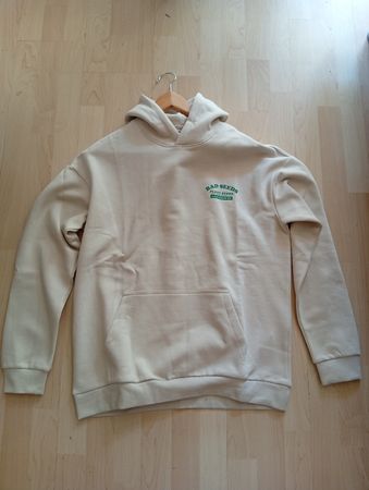Sweat à capuche beige avec motif vert neuf