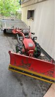 Einachs-Traktor Aebi mit Schneeschild und Anhänger