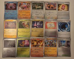 ​"15 Pokémon holo trading cards."