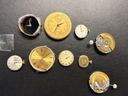Lot von Zifferblättern und Uhrwerken (Omega, IWC, Longines)