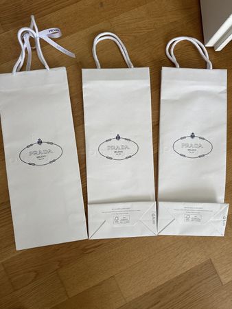 Drei Prada Papiertaschen