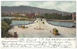 Zürich,   Quaibrücke.   (belebt m. Passanten, Trams, Pferde)