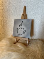 Toile brodée café en bon état 