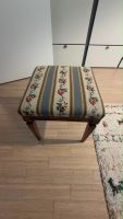 Vintage-style wooden upholstered stool. Comfortable padded