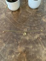 Armband Guess "LOVE" Anhänger goldfarben mit Steinbesatz