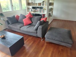 Grey Sofa with ottoman and red pillows