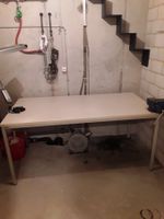 Tisch mit Schraubstock und Lampe