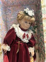 Puppe mit Blumenkranz im roten Kleid, Sammlerstück