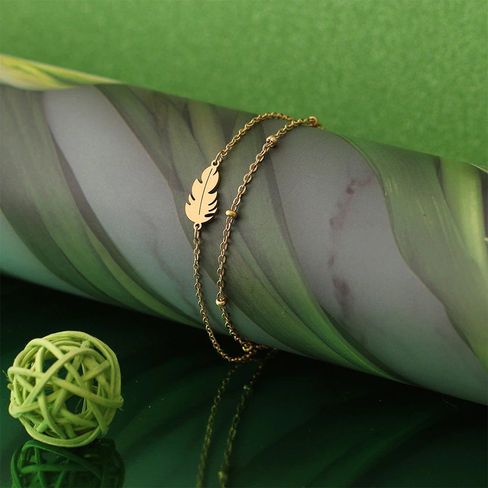 Armbänder & -reifen: Edelstahl Armband mit "Feder" Anhänger in GOLD – Neu und originalverpackt aus Tumegl/Tomils von Steinschleuder-Shop 3