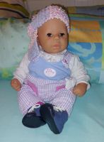 Puppenbaby Zapf Chouchou mit Kleidern.